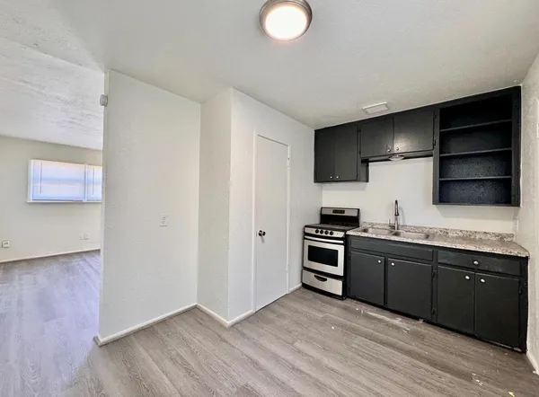 a kitchen with stainless steel appliances granite countertop a sink and a stove top oven
