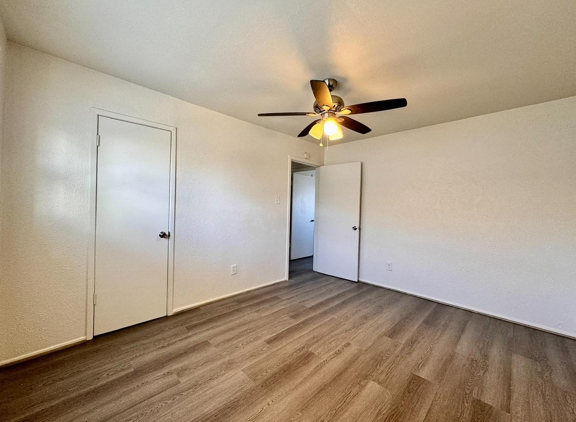 531 42nd Street Lubbock, TX 79404 - Photo 8 of 9 a view of empty room with wooden floor and fan