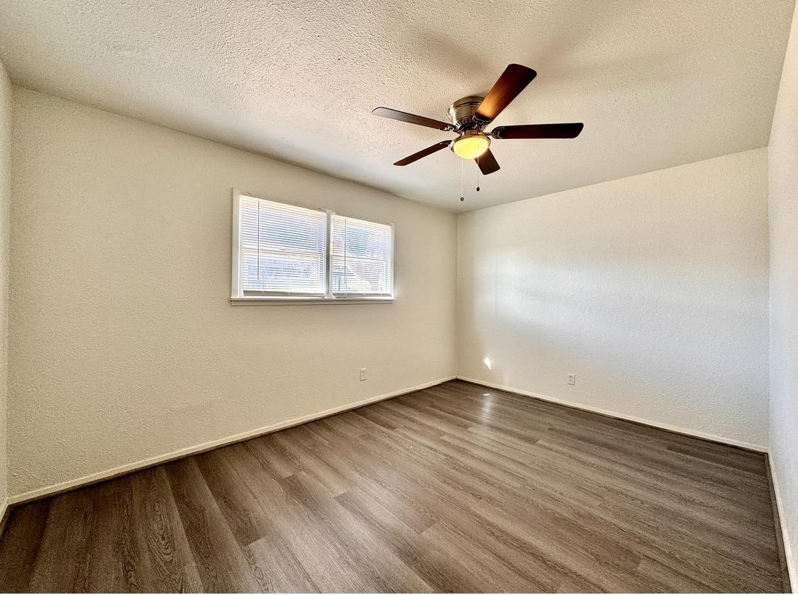 531 42nd Street Lubbock, TX 79404 - Photo 9 of 9 a view of an empty room with wooden floor and a window