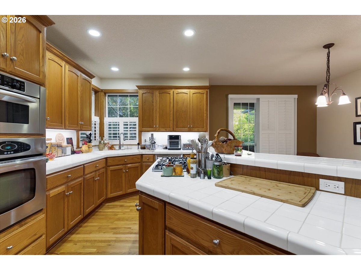 140 Gull Station Depoe Bay, OR 97341 - Photo 11 of 48 a kitchen with kitchen island granite countertop a sink cabinets and stainless steel appliances