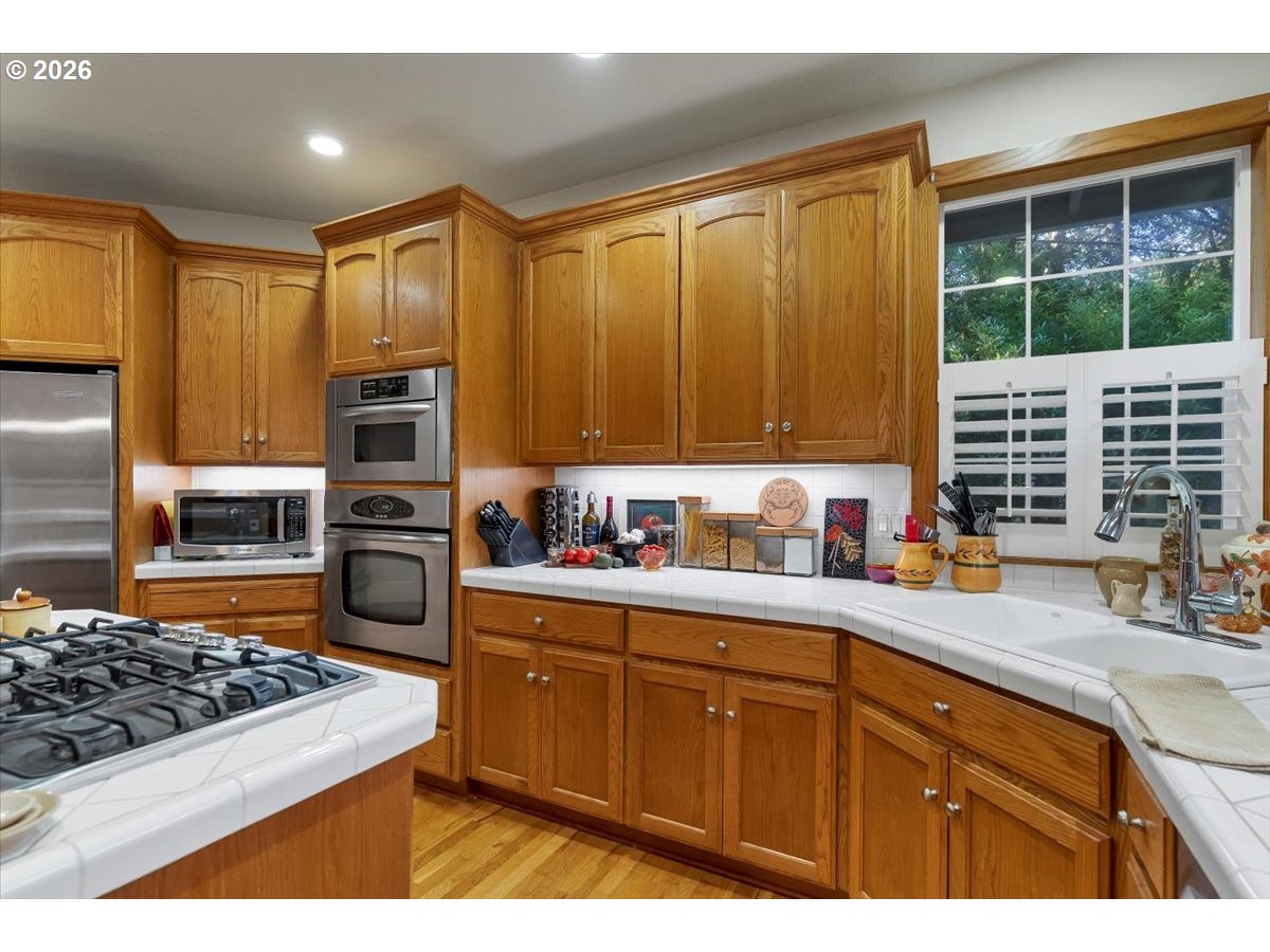 140 Gull Station Depoe Bay, OR 97341 - Photo 13 of 48 a kitchen with wooden cabinets and appliances