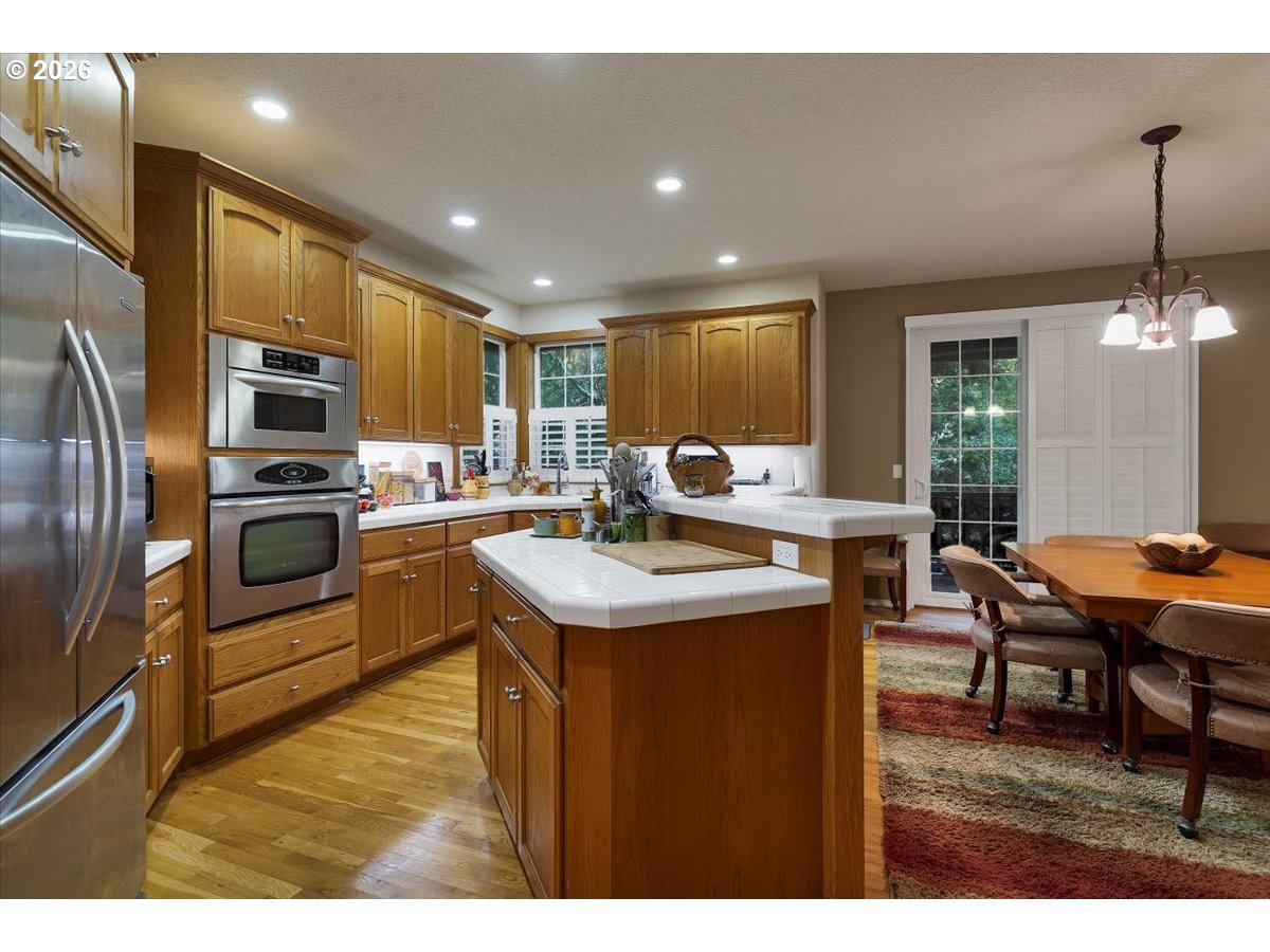 140 Gull Station Depoe Bay, OR 97341 - Photo 10 of 48 a kitchen with stainless steel appliances kitchen island granite countertop a sink and a refrigerator