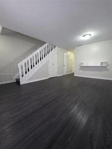 a view of an entryway with wooden floor