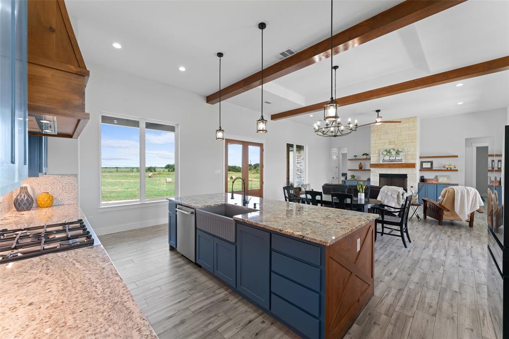 4411 Fm 751 Wills Point Wills Point, TX 75169 - Photo 17 of 40 Spacious kitchen featuring a large island with granite countertops, an integrated farmhouse sink, and a stainless steel dishwasher