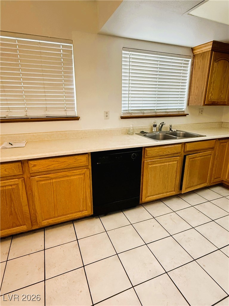 5311 South Sandhill Road Las Vegas, NV 89120 - Photo 12 of 24 Kitchen with brown cabinets, light countertops, dishwasher, and light tile patterned floors