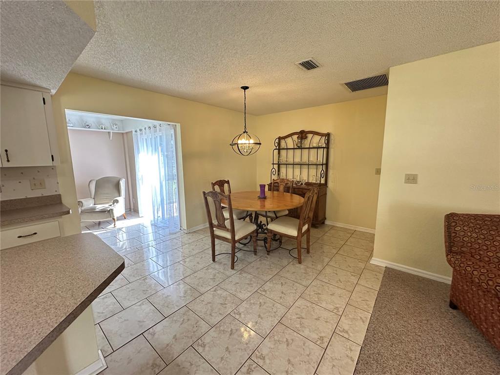 8981 Southwest 116th Street Road Ocala, FL 34481 - Photo 14 of 28 a view of a dining room with furniture