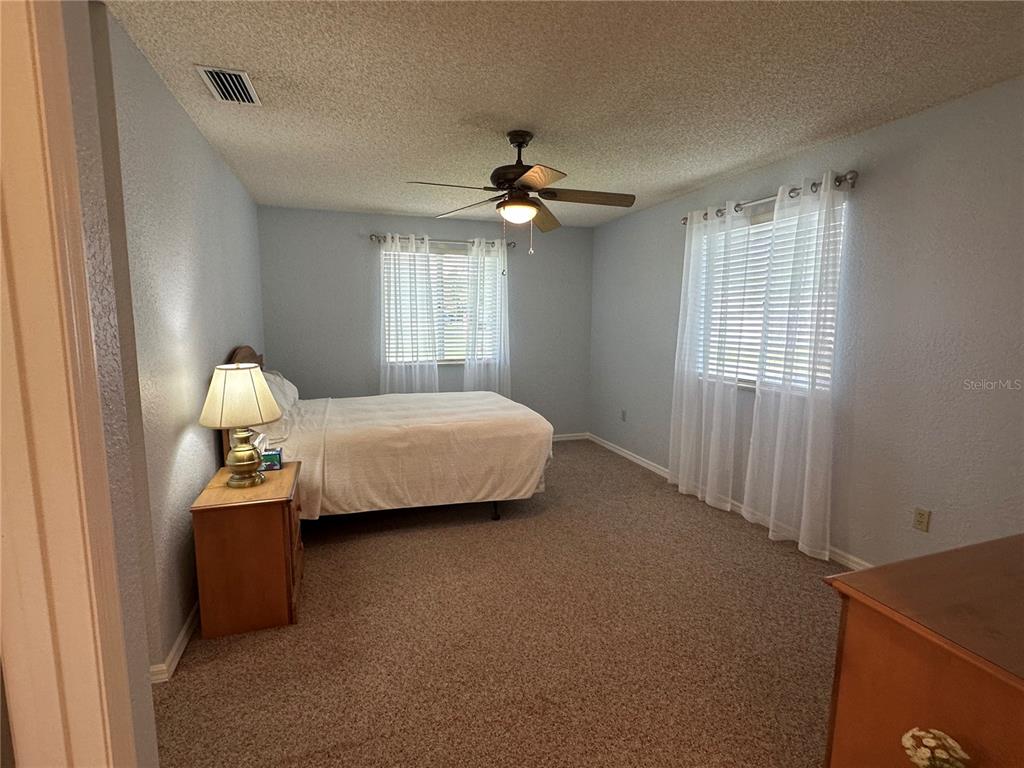 8981 Southwest 116th Street Road Ocala, FL 34481 - Photo 17 of 28 a bedroom with a bed and a window