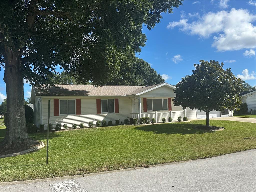 8981 Southwest 116th Street Road Ocala, FL 34481 - Photo 2 of 28 a front view of a house with a garden