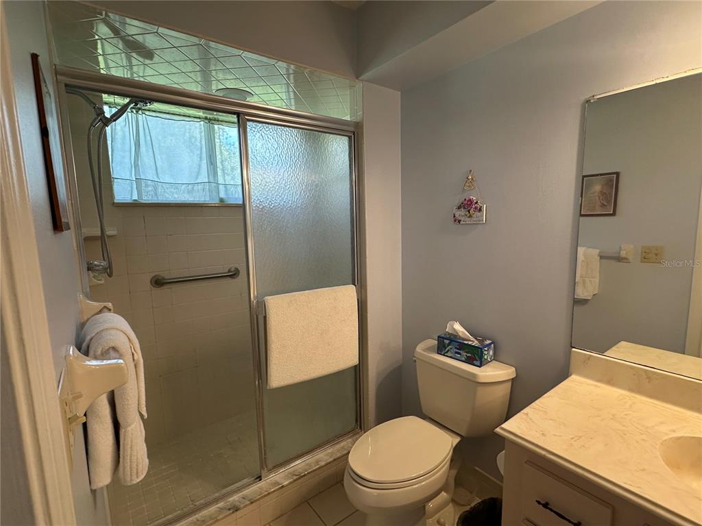 8981 Southwest 116th Street Road Ocala, FL 34481 - Photo 21 of 28 a white toilet sitting next to a bathroom sink