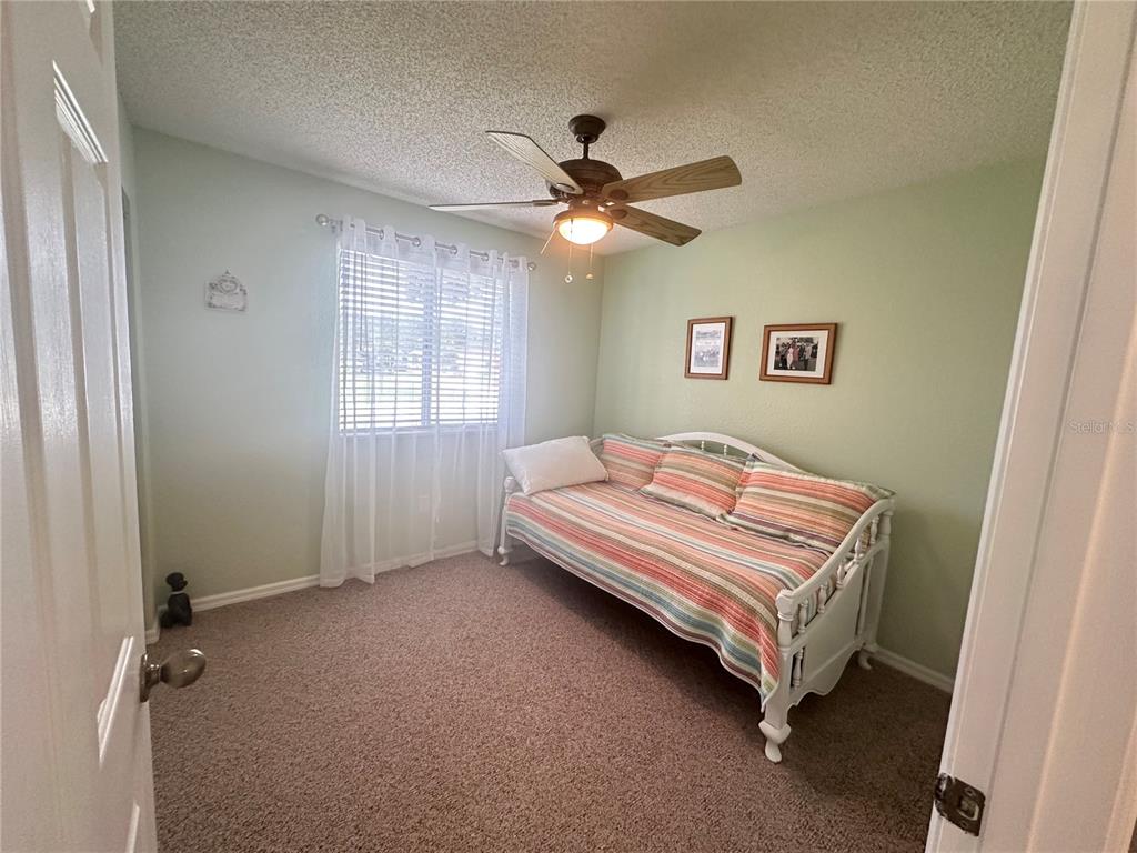 8981 Southwest 116th Street Road Ocala, FL 34481 - Photo 22 of 28 a bedroom with a bed and a window