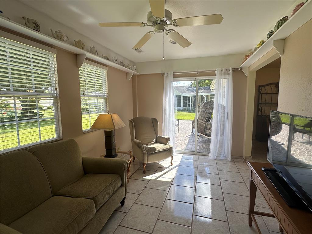 8981 Southwest 116th Street Road Ocala, FL 34481 - Photo 26 of 28 a living room with furniture and a flat screen tv