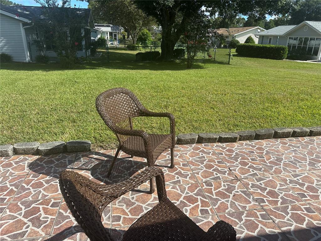 8981 Southwest 116th Street Road Ocala, FL 34481 - Photo 27 of 28 a view of a chair and table on the garden