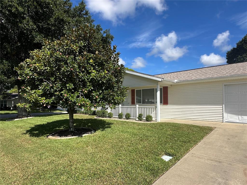 8981 Southwest 116th Street Road Ocala, FL 34481 - Photo 3 of 28 a front view of a house with a yard