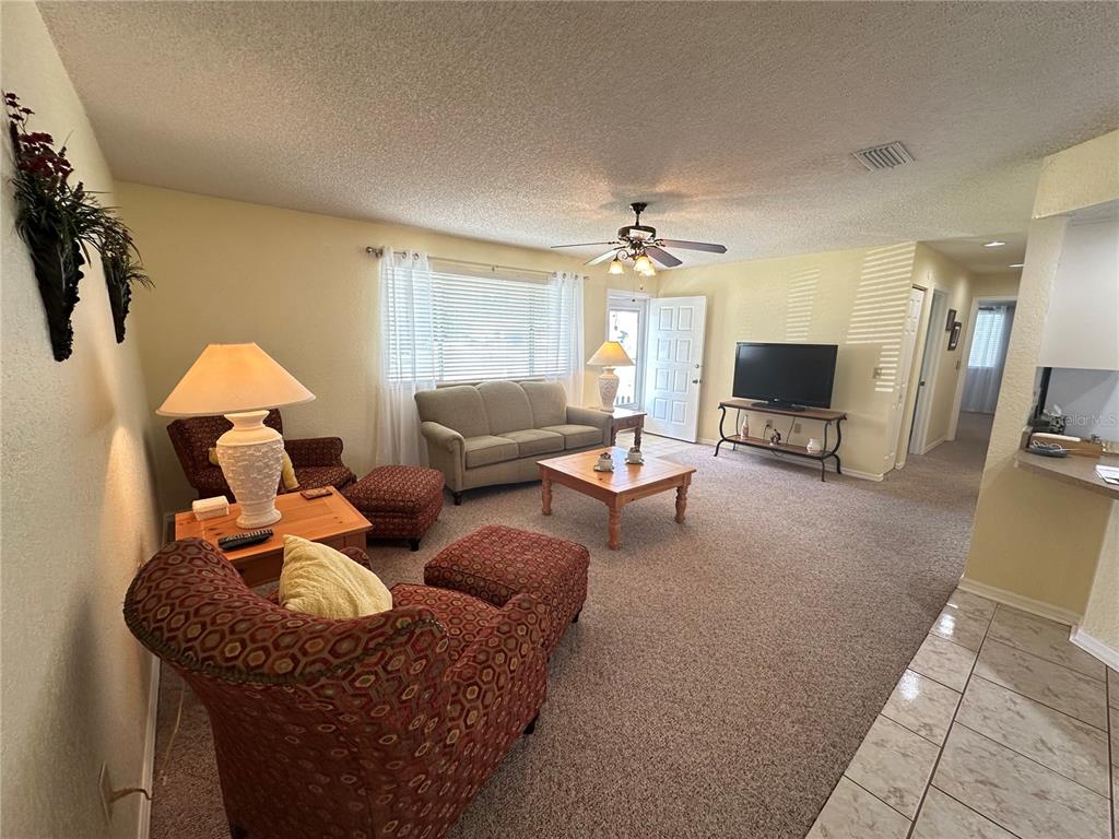 8981 Southwest 116th Street Road Ocala, FL 34481 - Photo 9 of 28 a living room with furniture and a flat screen tv
