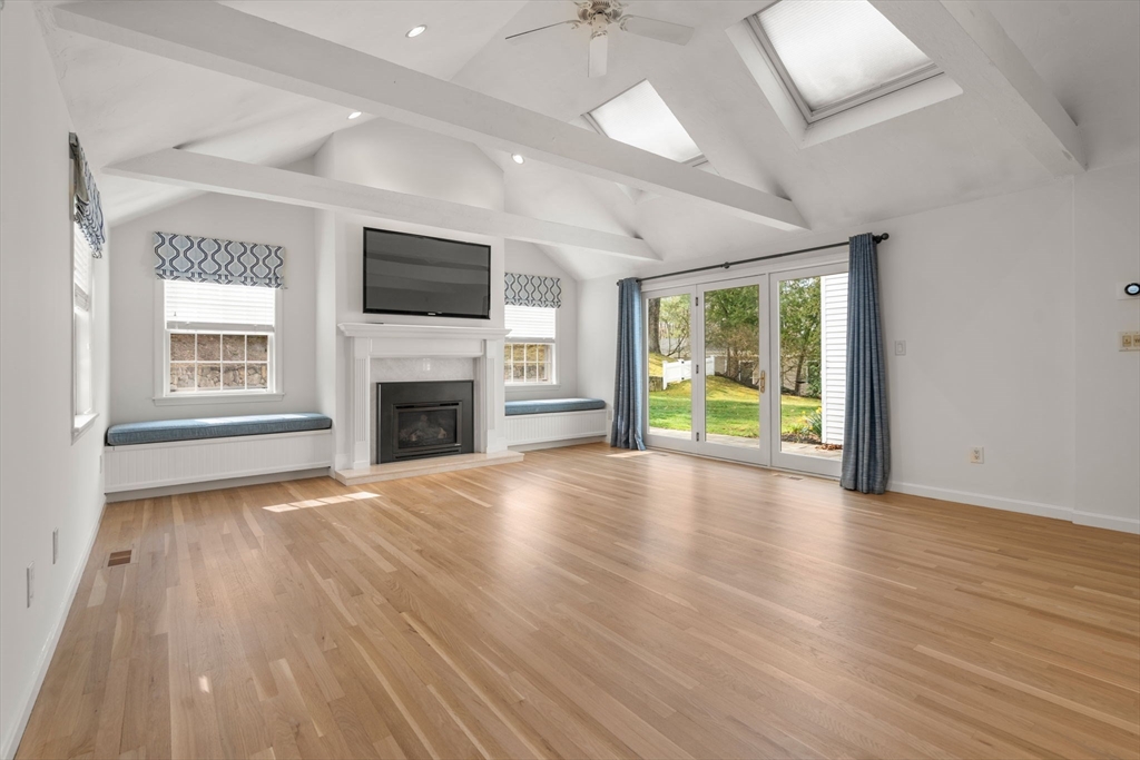 96 Bristol Road Wellesley, MA 02481 - Photo 3 of 31 an empty room with wooden floor fireplace and windows
