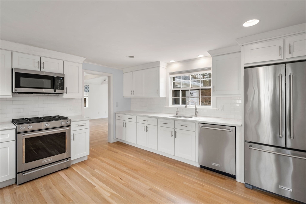 96 Bristol Road Wellesley, MA 02481 - Photo 7 of 31 a kitchen with granite countertop a refrigerator stove and microwave