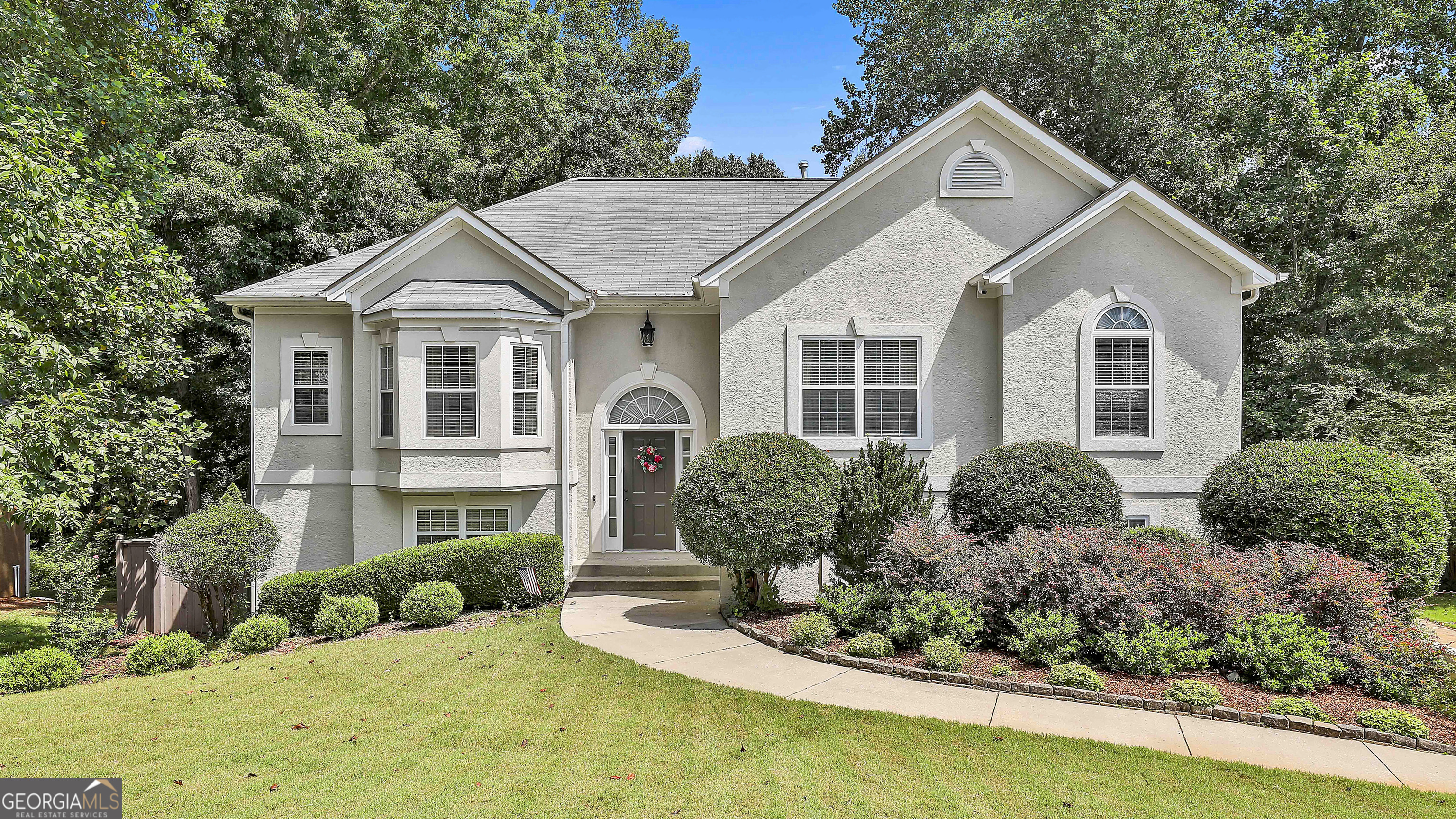 a front view of a house with a yard