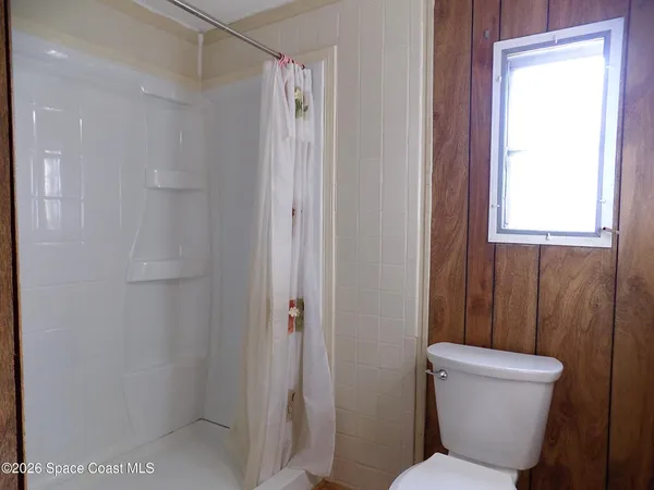 a bathroom with a glass shower door