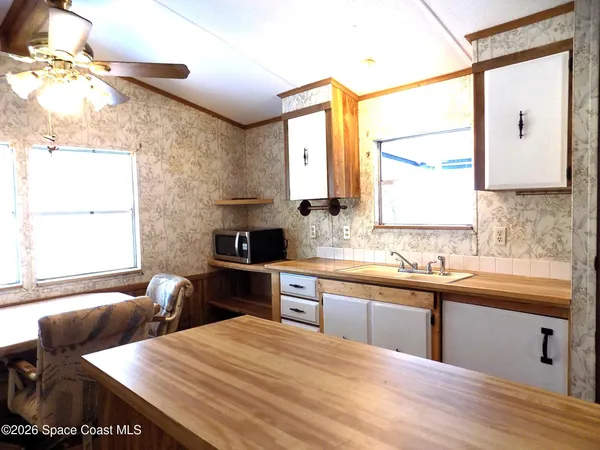 a kitchen with a sink and wooden cabinets