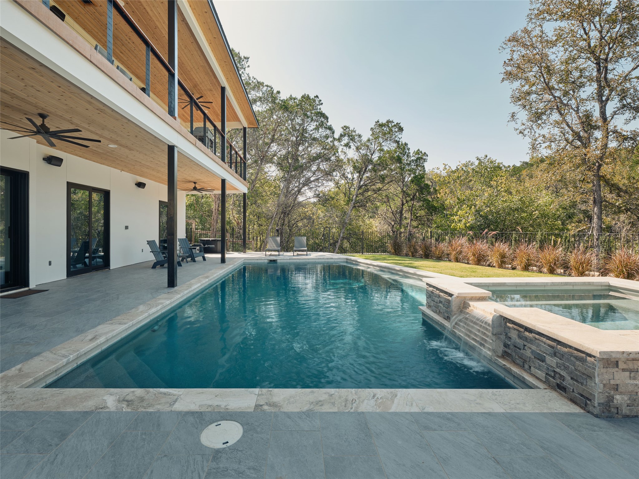 3214 Smoky Ridge, Unit LOT A Austin, TX 78730 - Photo 24 of 32 View of swimming pool featuring a patio, a ceiling fan, a pool with connected hot tub, and a balcony
