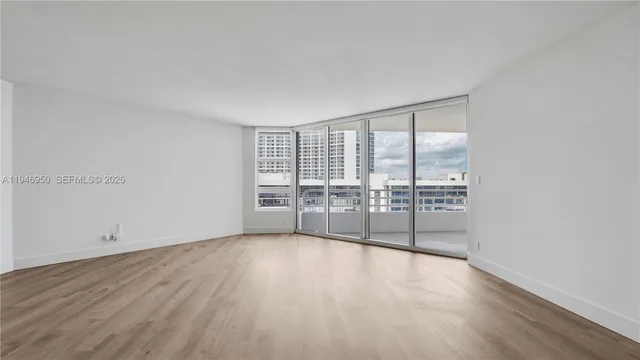 a view of a room with wooden floor and window