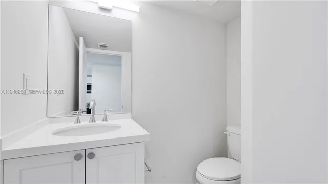 a bathroom with a sink a toilet and mirror