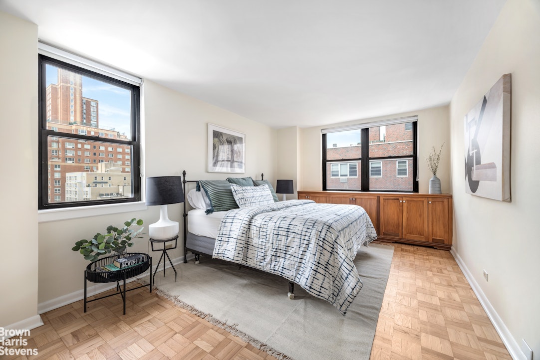 239 East 79th Street, Unit 12P Manhattan, NY 10075 - Photo 5 of 9 a living room with a bed furniture and next to a window