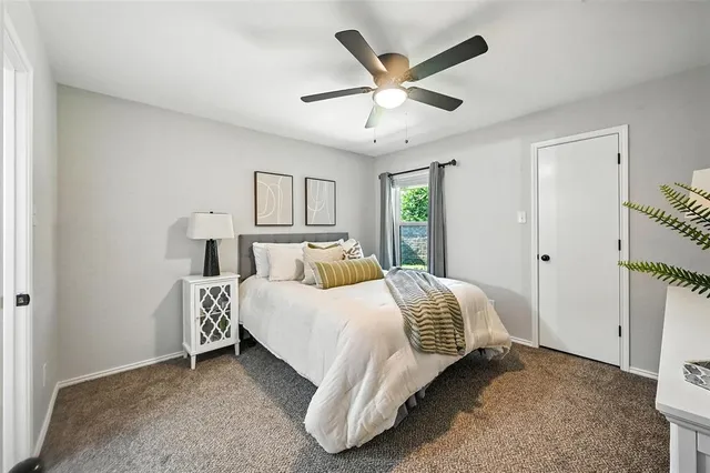a bedroom with a bed and a ceiling fan