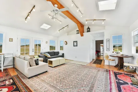 a living room with furniture a rug and a window