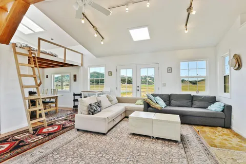 a dining room with furniture and a window