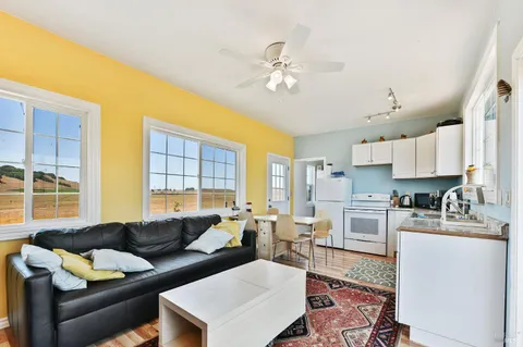 a kitchen with granite countertop a sink a stove and cabinets