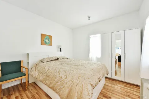 a bathroom with a granite countertop sink a mirror and shower