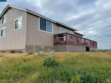 a living room with pool table and a large window
