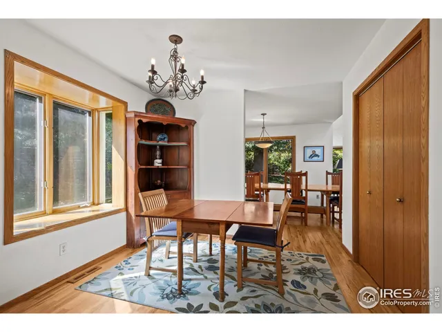 a dining room with furniture window and wooden floor