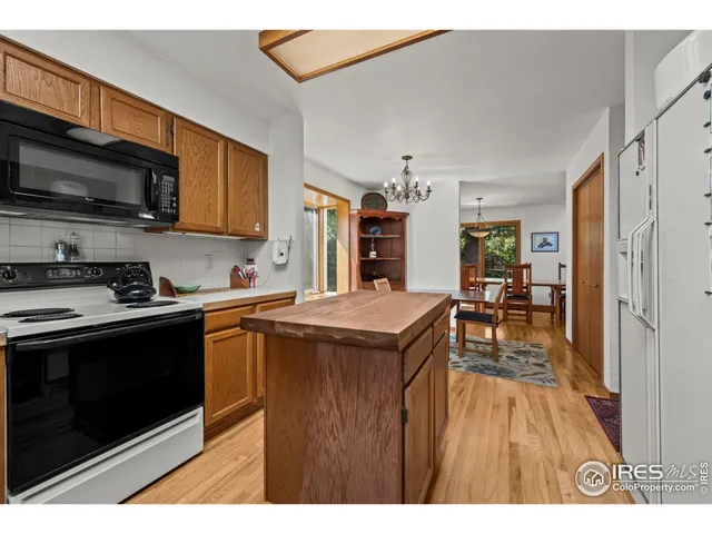 a kitchen with stainless steel appliances granite countertop a stove top oven a sink dishwasher and a microwave oven on the blue kitchen countertops
