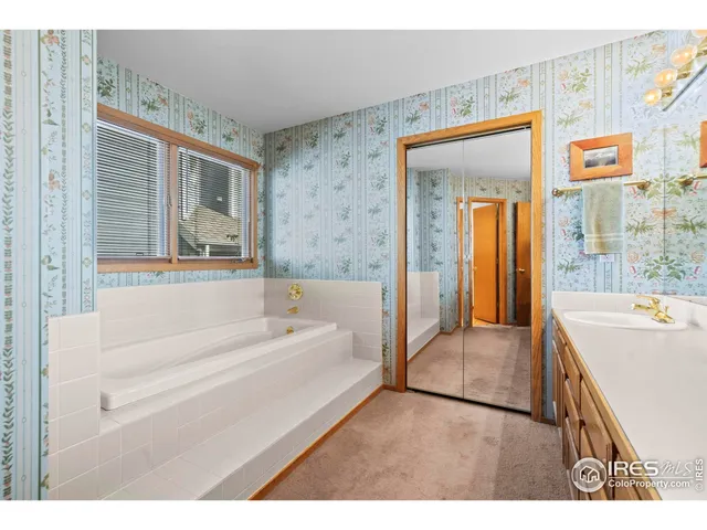 a en suite bathroom with a tub shower and sink