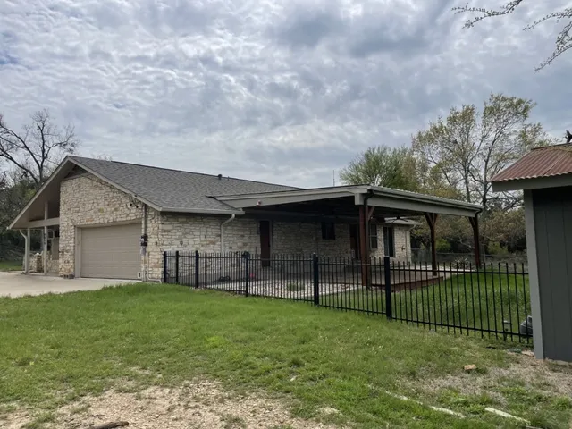 a view of a house with a yard and sitting area