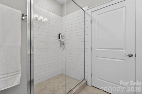 a bathroom with a glass shower door