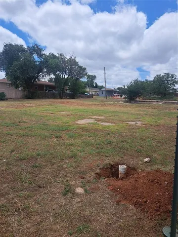 a view of a lake with houses in back