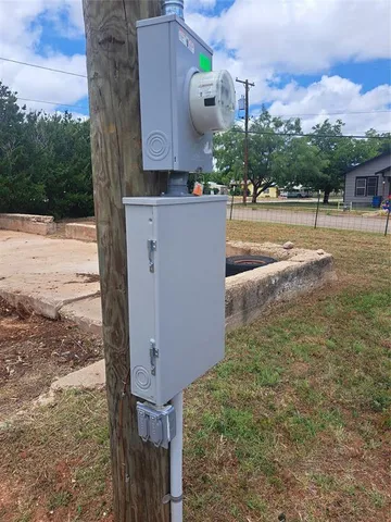 a view of a wall with a table and a clock on it