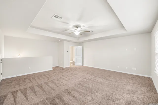 a view of an empty room with a ceiling fan