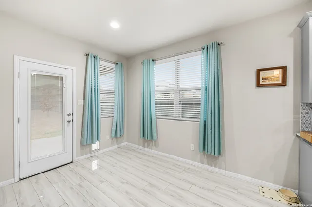 a view of a room with wooden floor and windows