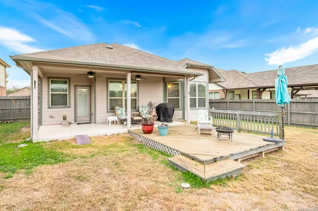 a view of a house with backyard and sitting area
