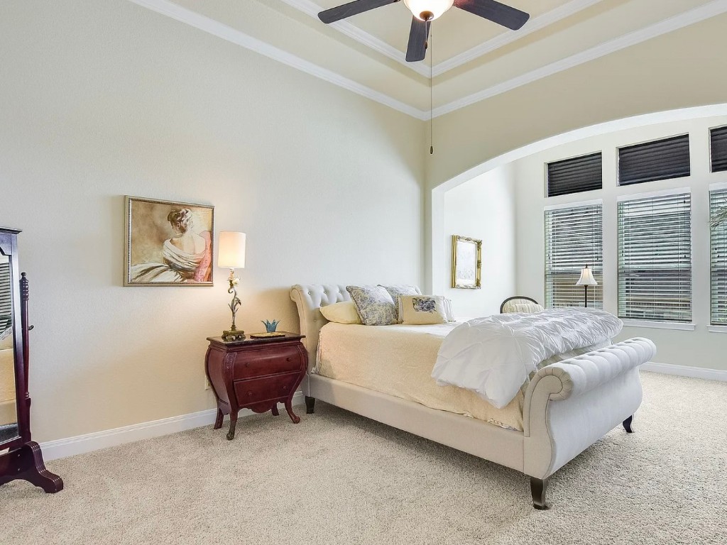 106 Evolutions Path Austin, TX 78738 - Photo 12 of 24 a spacious bedroom with a bed and a large window