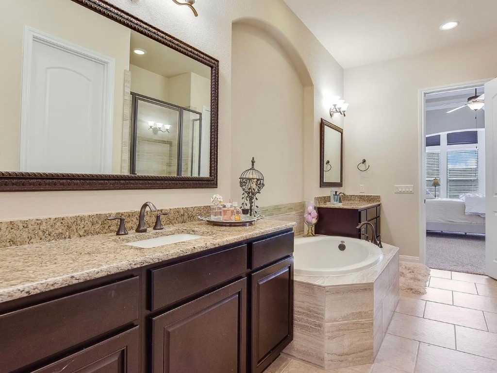 106 Evolutions Path Austin, TX 78738 - Photo 15 of 24 a en suite bathroom with a sink double vanity and a mirror