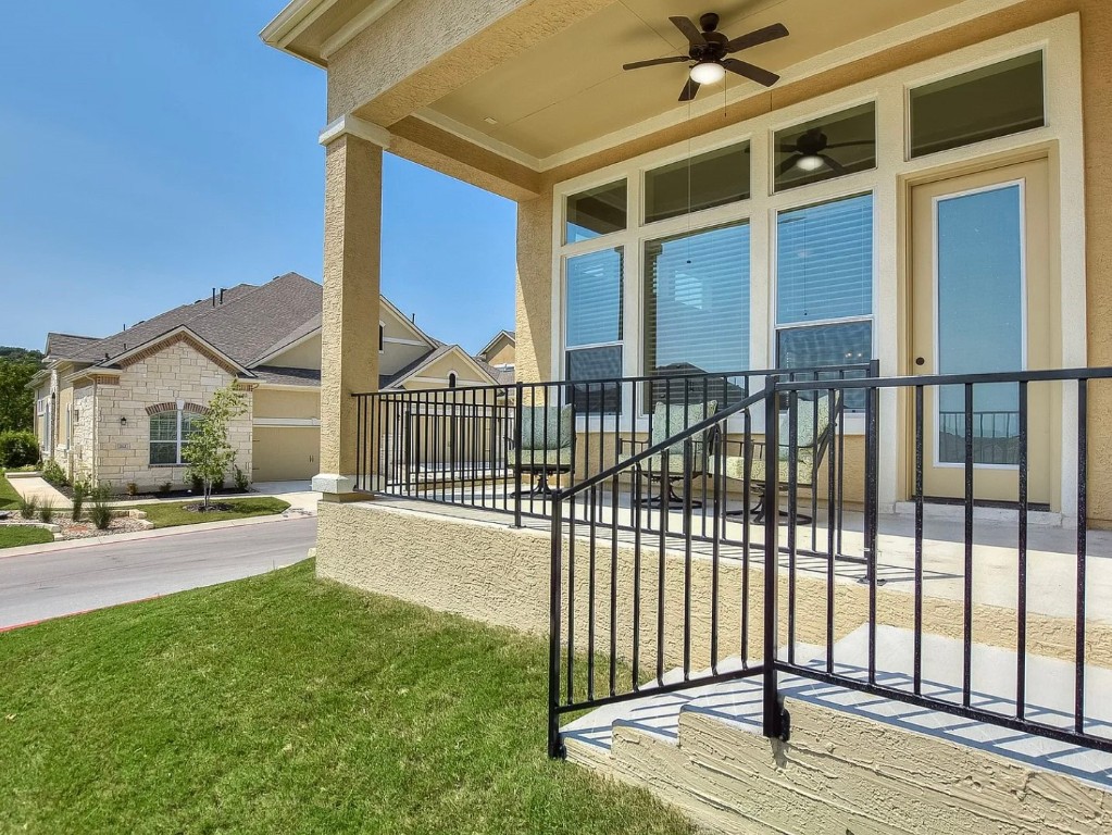 106 Evolutions Path Austin, TX 78738 - Photo 18 of 24 a view of a house with a floor to ceiling window and wooden fence