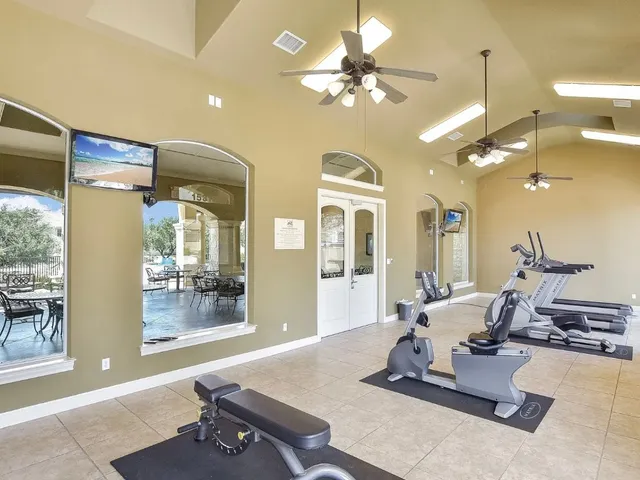 a room with gym equipment and view of living room