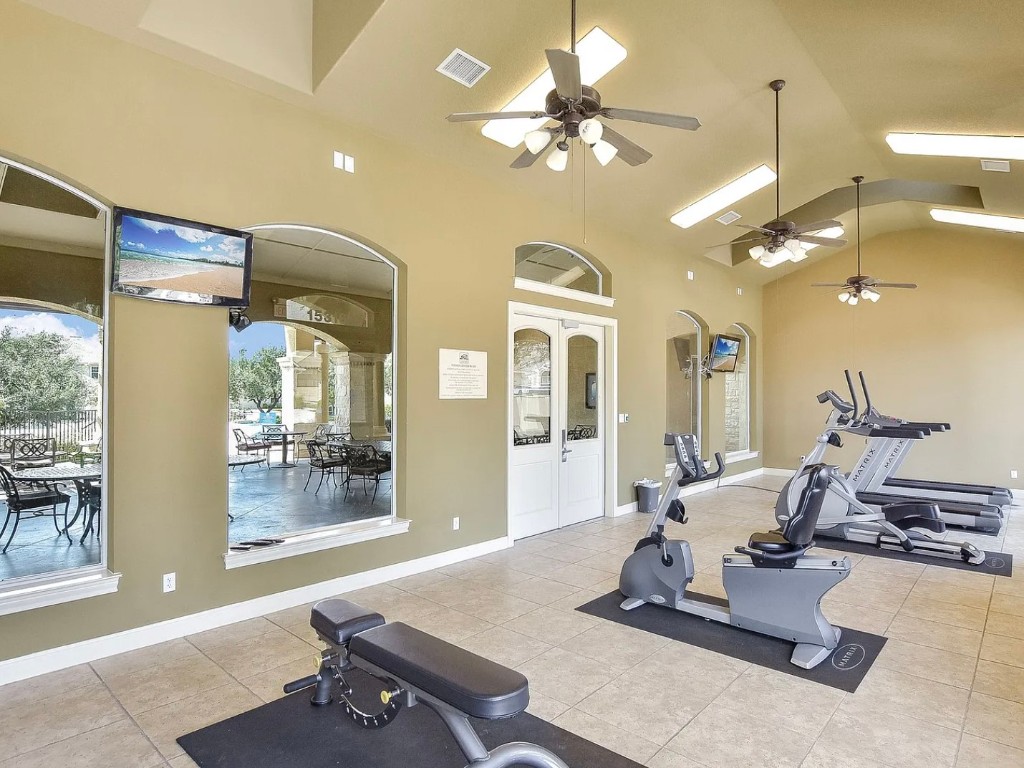 106 Evolutions Path Austin, TX 78738 - Photo 20 of 24 a room with gym equipment and view of living room