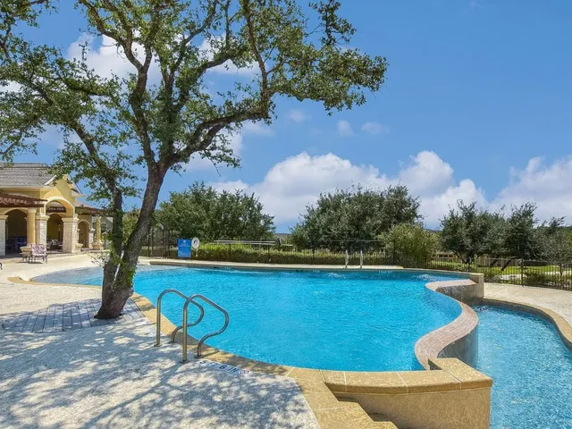a view of a yard with swimming pool