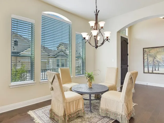 a view of a dining room with furniture wooden floor and chandelier